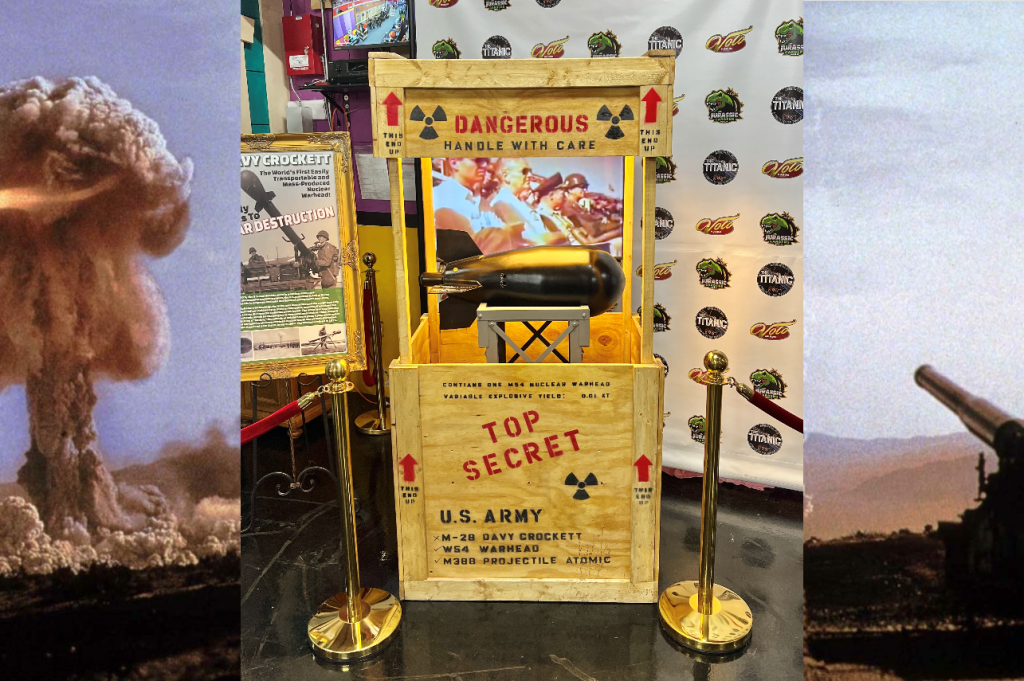 Exhibit display of a Cold War–era nuclear bomb warhead in a wooden crate with “Top Secret” and “Dangerous” markings at Volo Fun museum