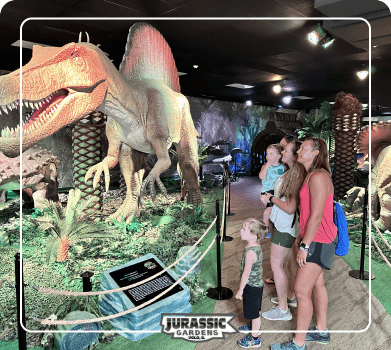 Jurassic Gardens dinosaur exhibit background with life-size roaring dinosaurs and prehistoric foliage at Jurassic Gardens at Volo Museum in Illinois