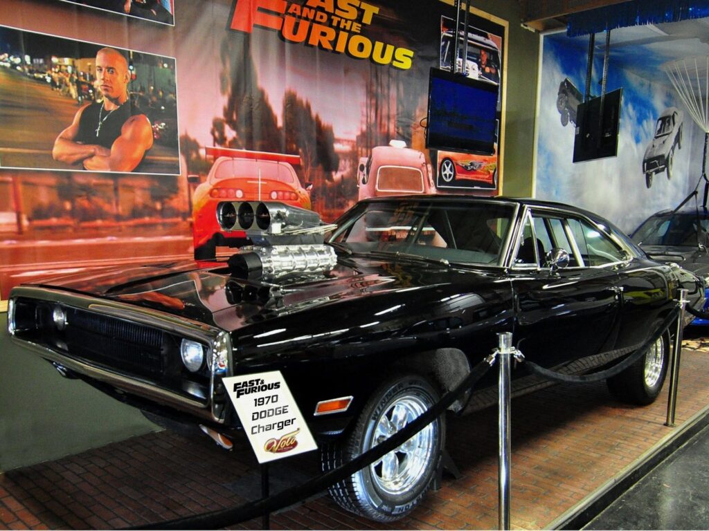 A classic 1970 Dodge Charger muscle car shown from the front-three-quarter angle, with a long sleek hood, hidden headlights behind a full-width grille, and a fastback roofline typical of late-1960s/early-1970s American muscle cars.