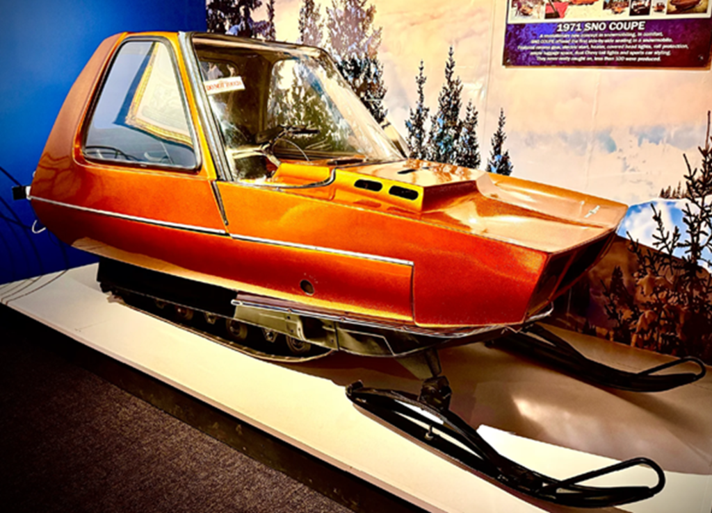 Vintage orange snowmobile on display