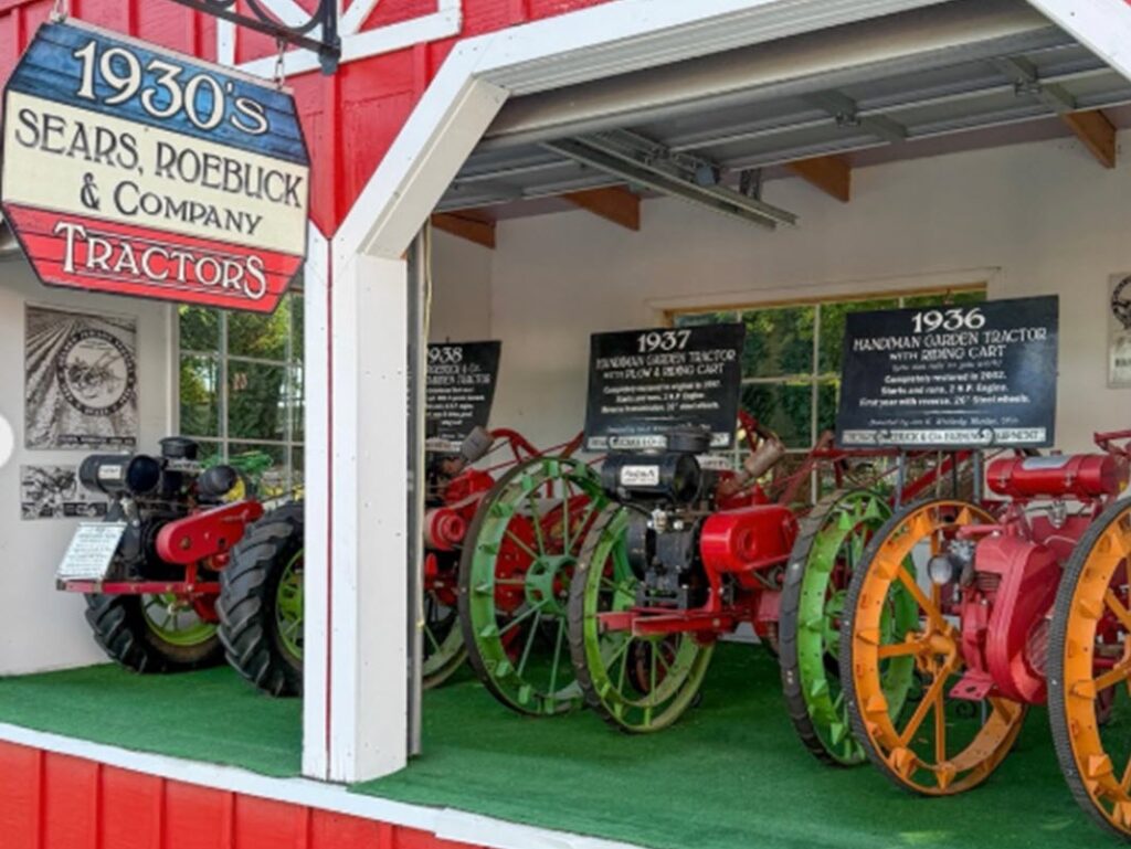 Vintage tractors on display indoors.