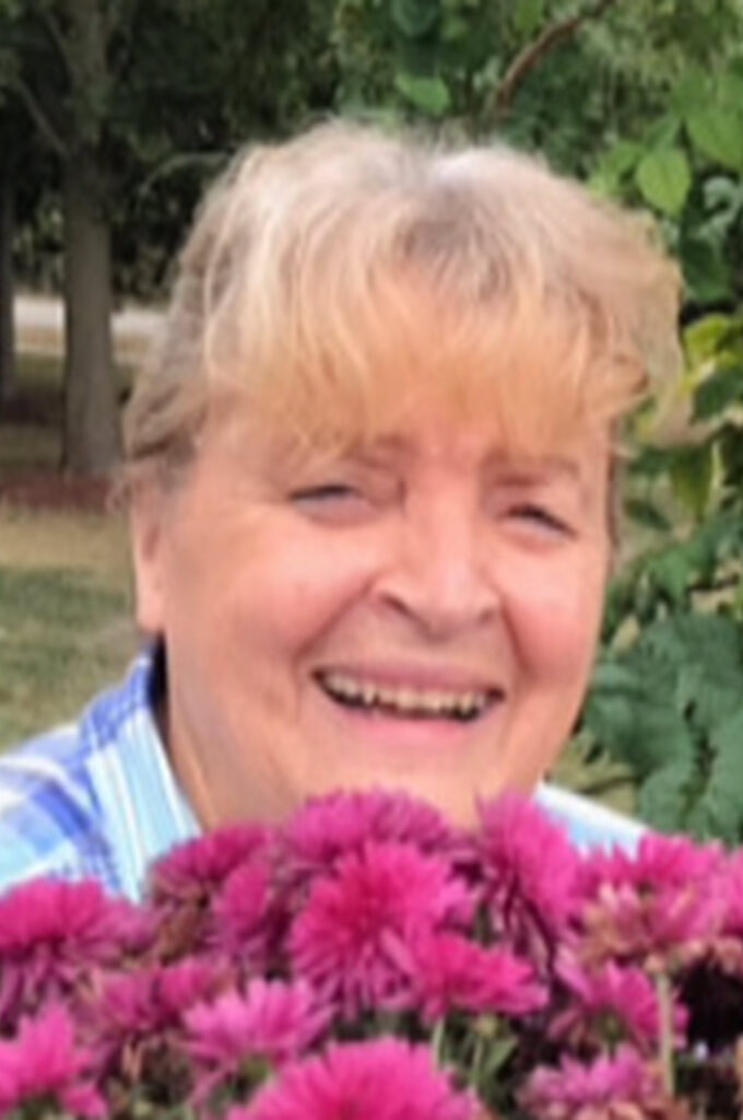 Person surrounded by pink flowers.