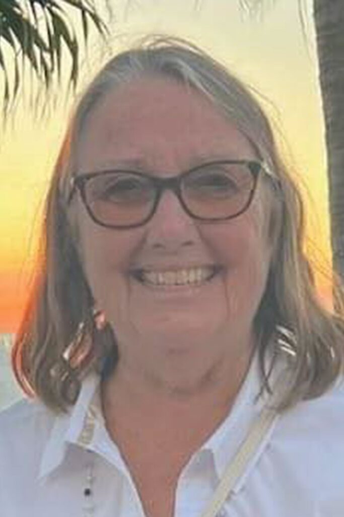 Person standing by the beach sunset.