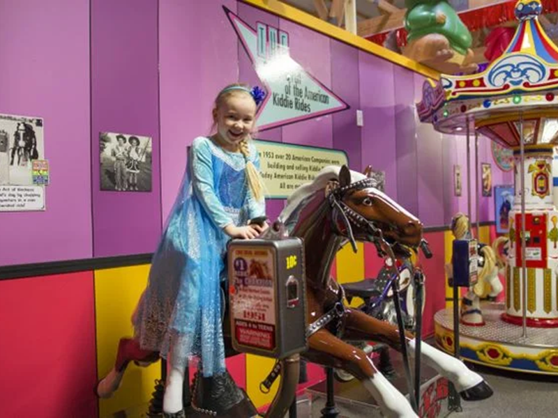 Child riding a mechanical horse.