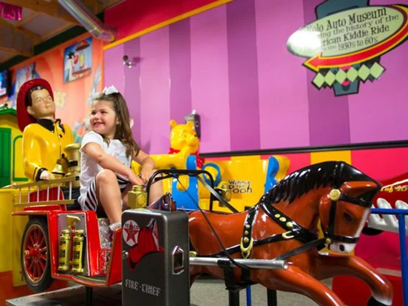 Child riding a vintage kiddie ride