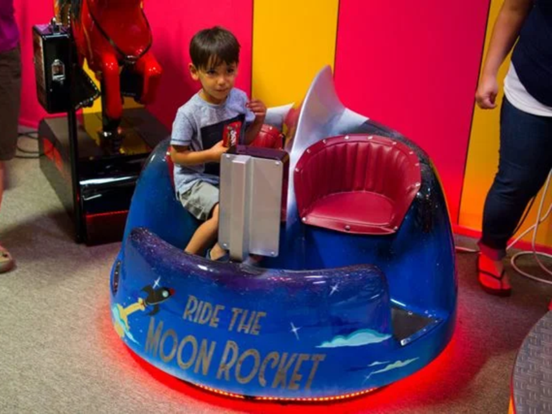 Child on colorful amusement ride