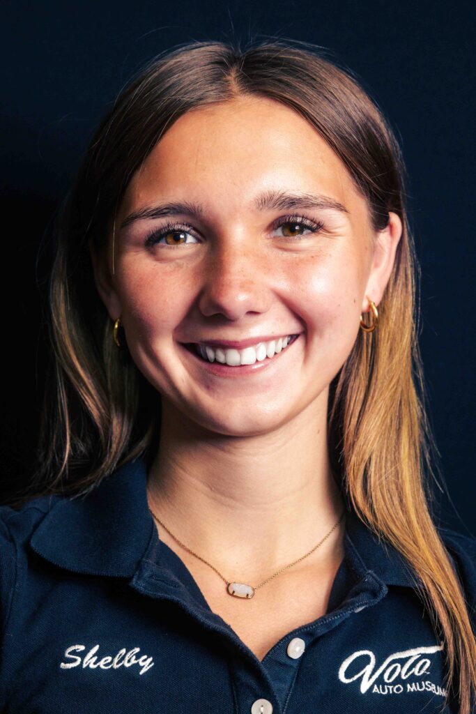 Person wearing a dark polo shirt.