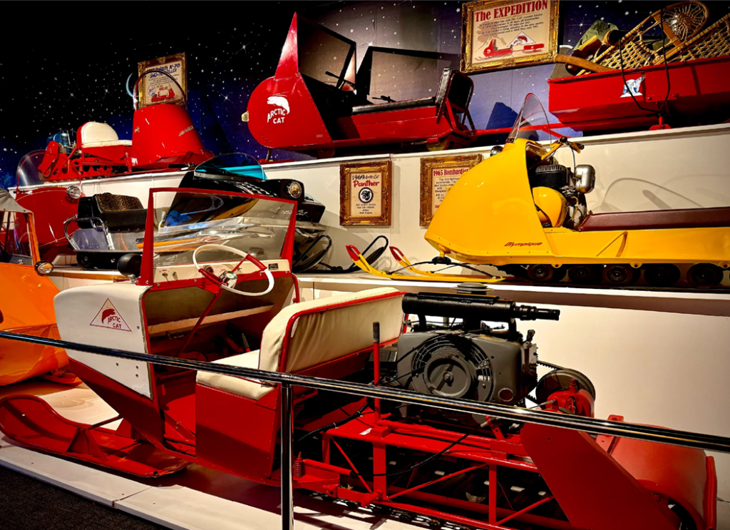 Colorful vintage snowmobiles on display