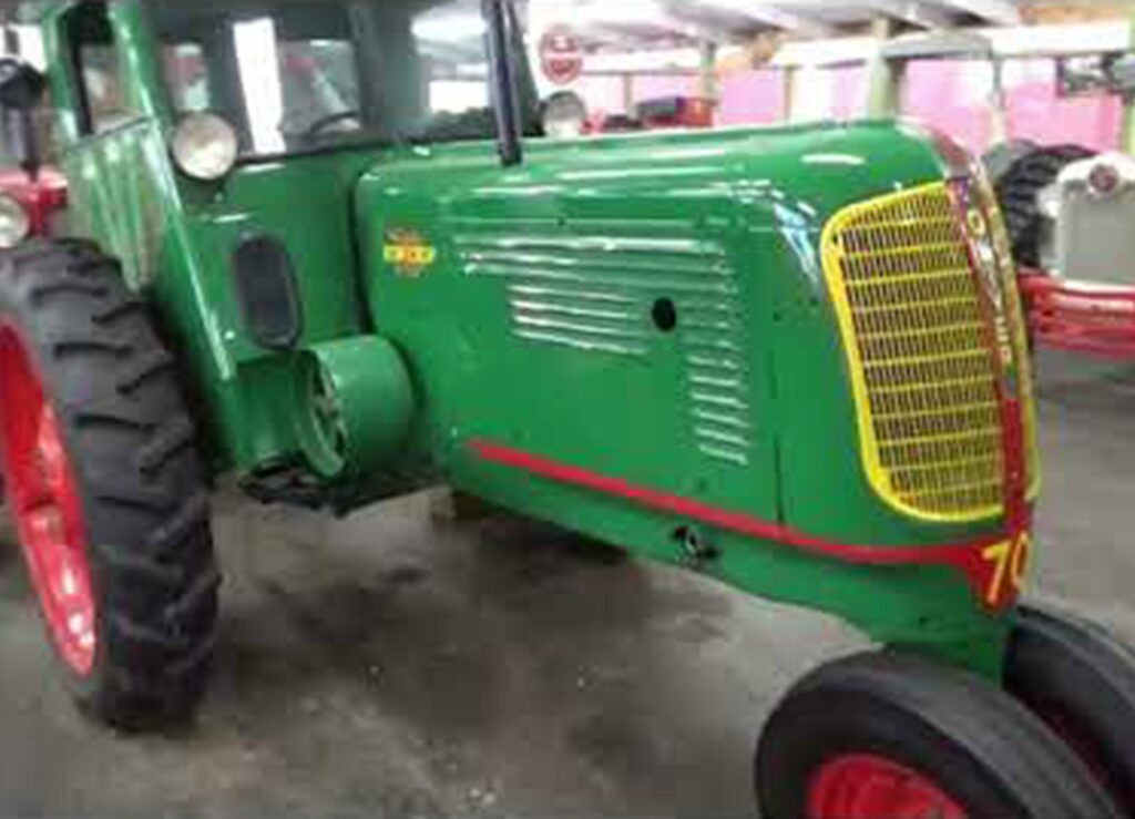 Vintage green tractor with red wheels