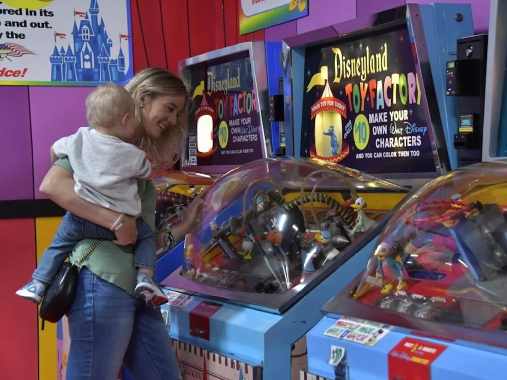 Child and adult at toy machines.