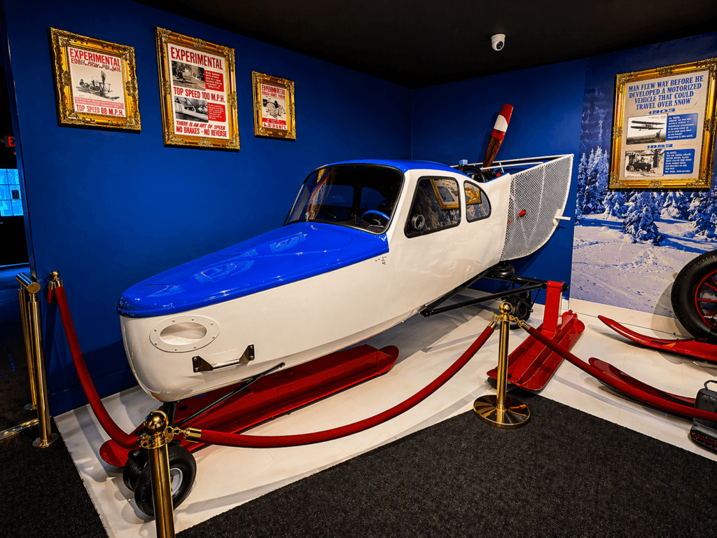 Vintage aircraft SNOW MACHINE on display indoors.