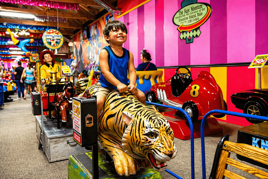 Child riding a toy tiger.