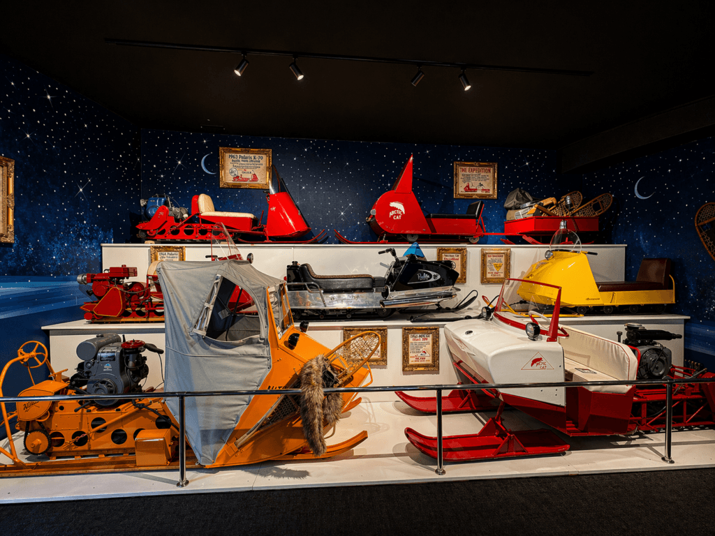 Colorful vintage snowmobiles on display