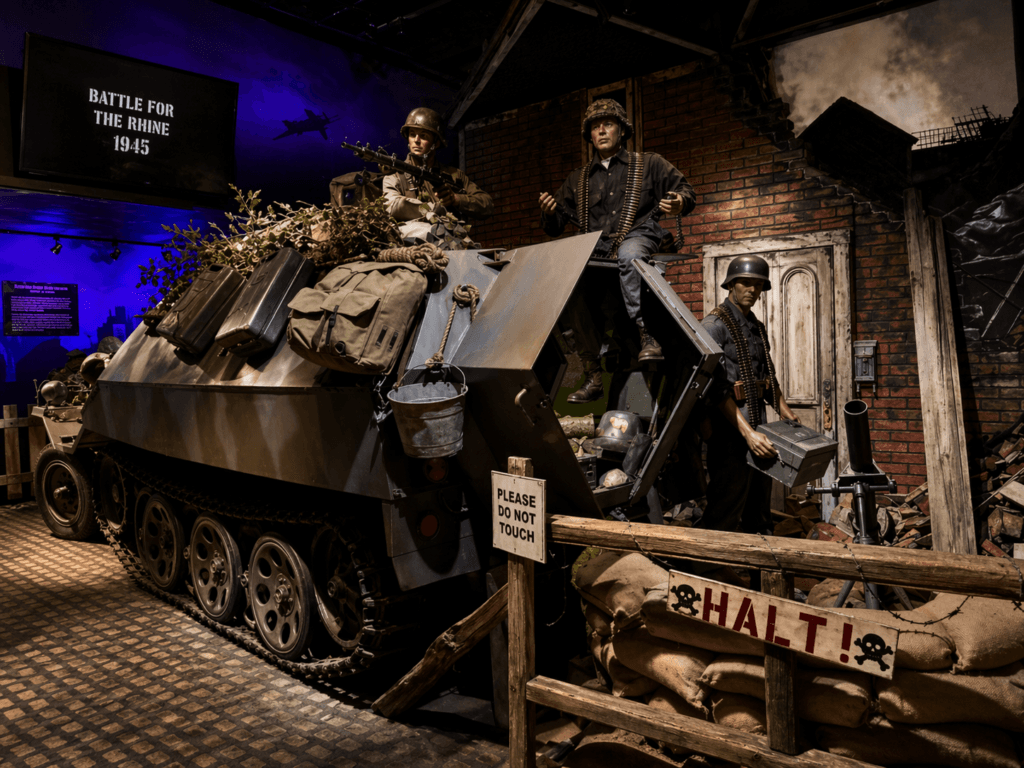Military exhibit with soldiers and vehicle