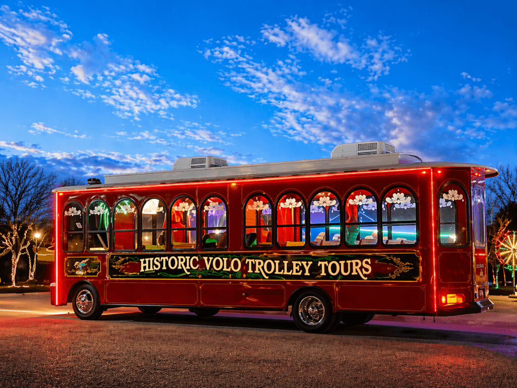 Red trolley bus with festive lights