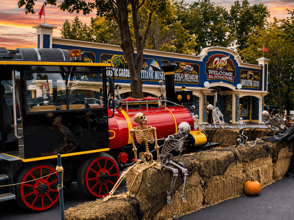 Skeletons near a festive train display