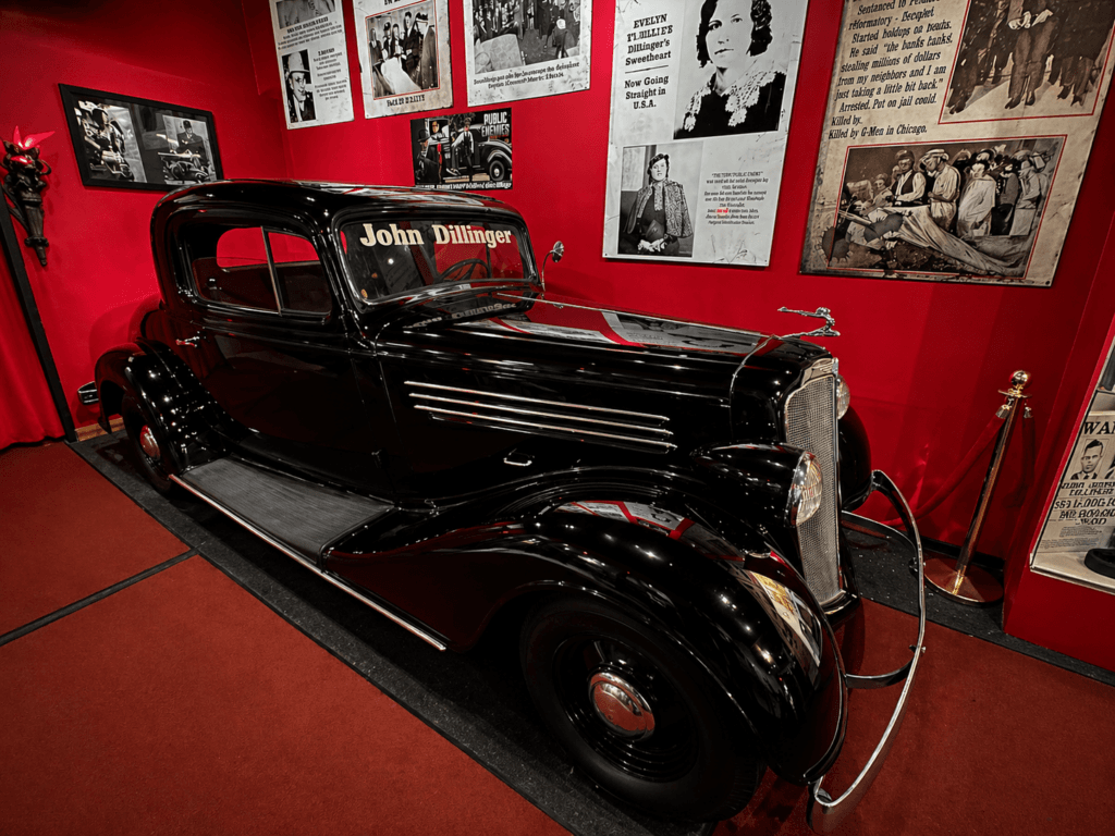John Dillinger Vintage car displayed in museum setting.