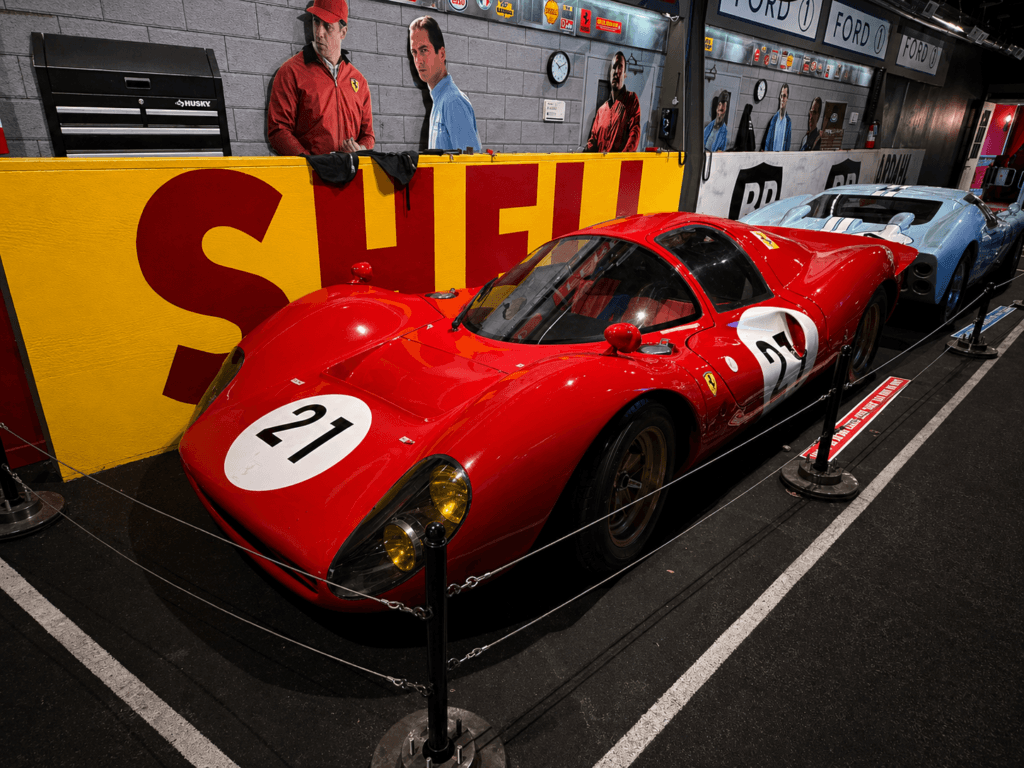 Classic red race car in garage at the ford vs ferrari exhibit at volo museum