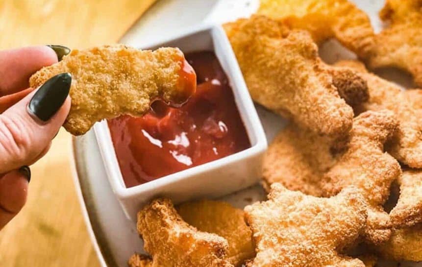 Dinosaur-shaped nuggets with dipping sauce