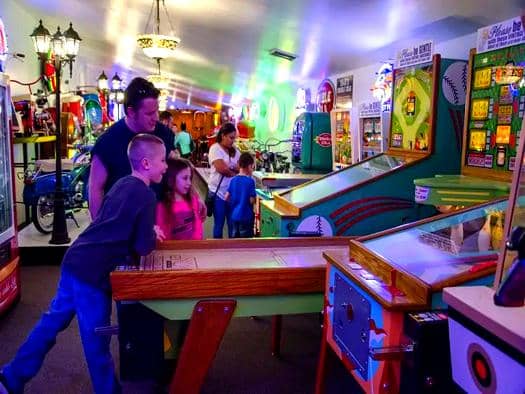 Vibrant arcade area filled with colorful game machines and bright lighting