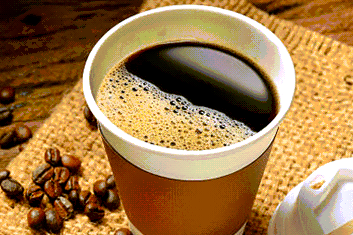 Coffee cup with beans and foam