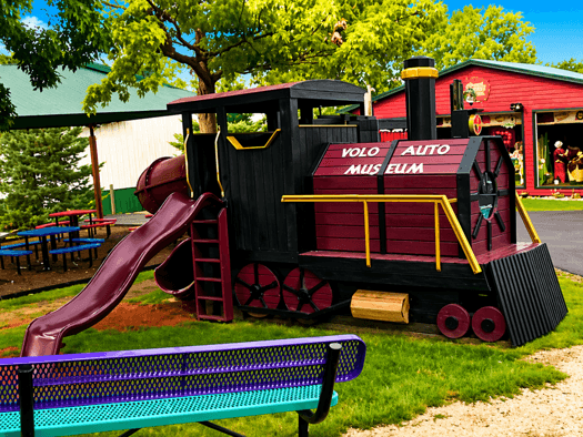 Train moving along railway tracks in a scenic outdoor setting