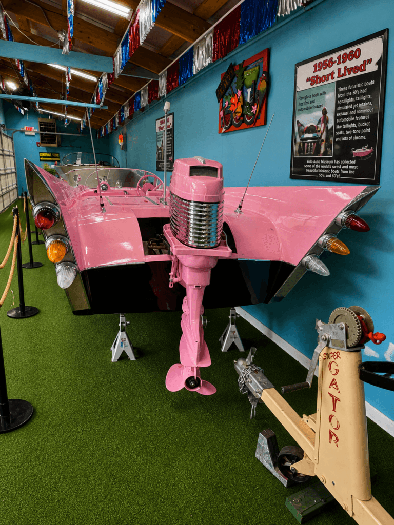 Pink vintage boat with outboard motor
