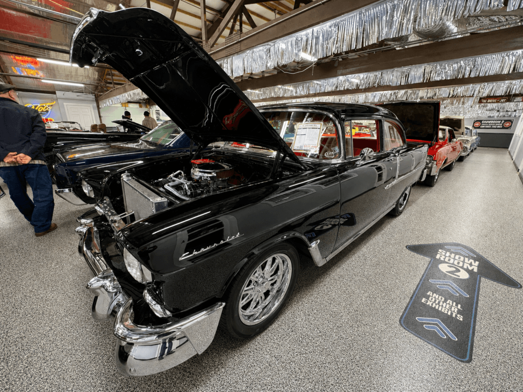 Classic black car in showroom.