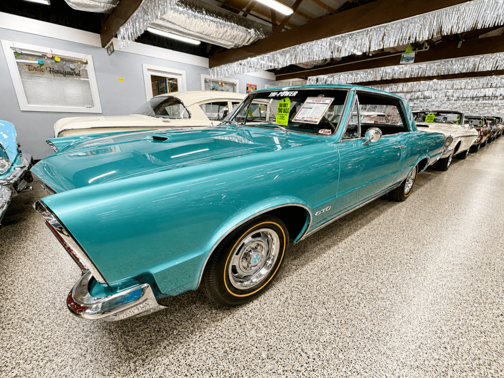 Classic turquoise car in showroom
