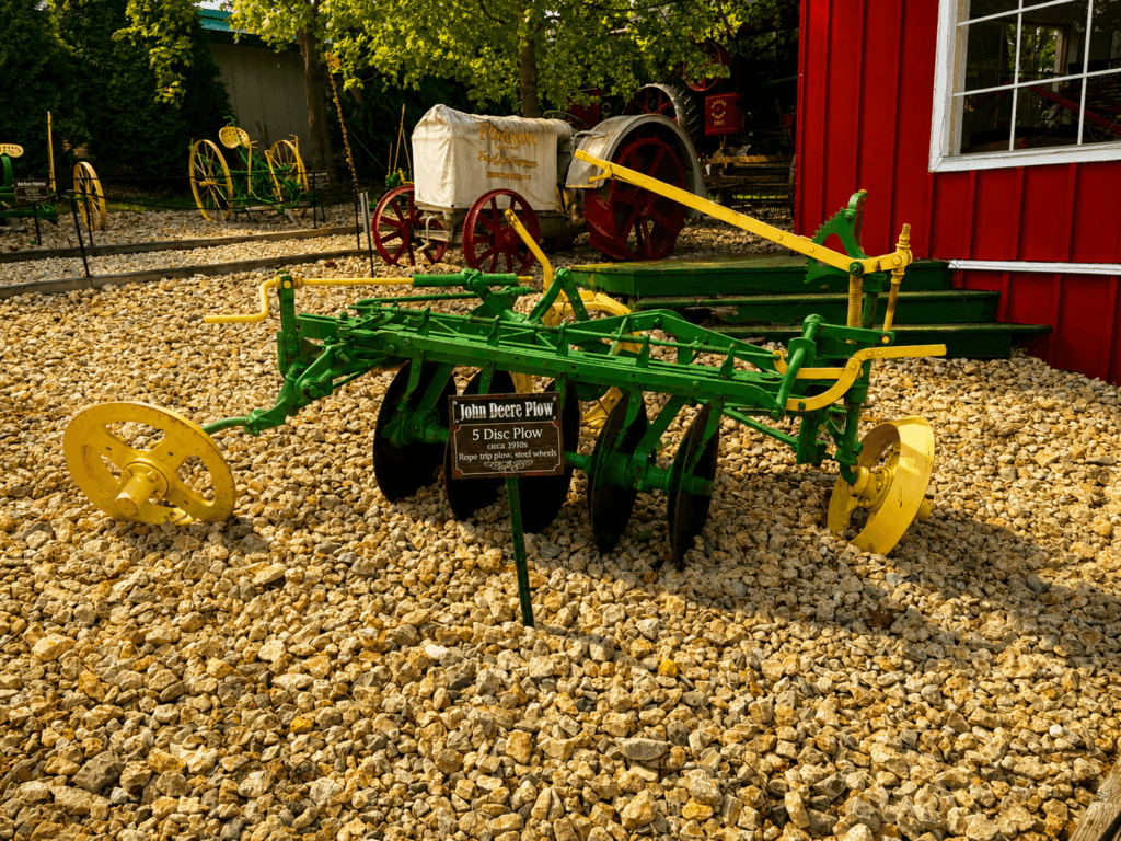 John Deere plow displayed outdoors.