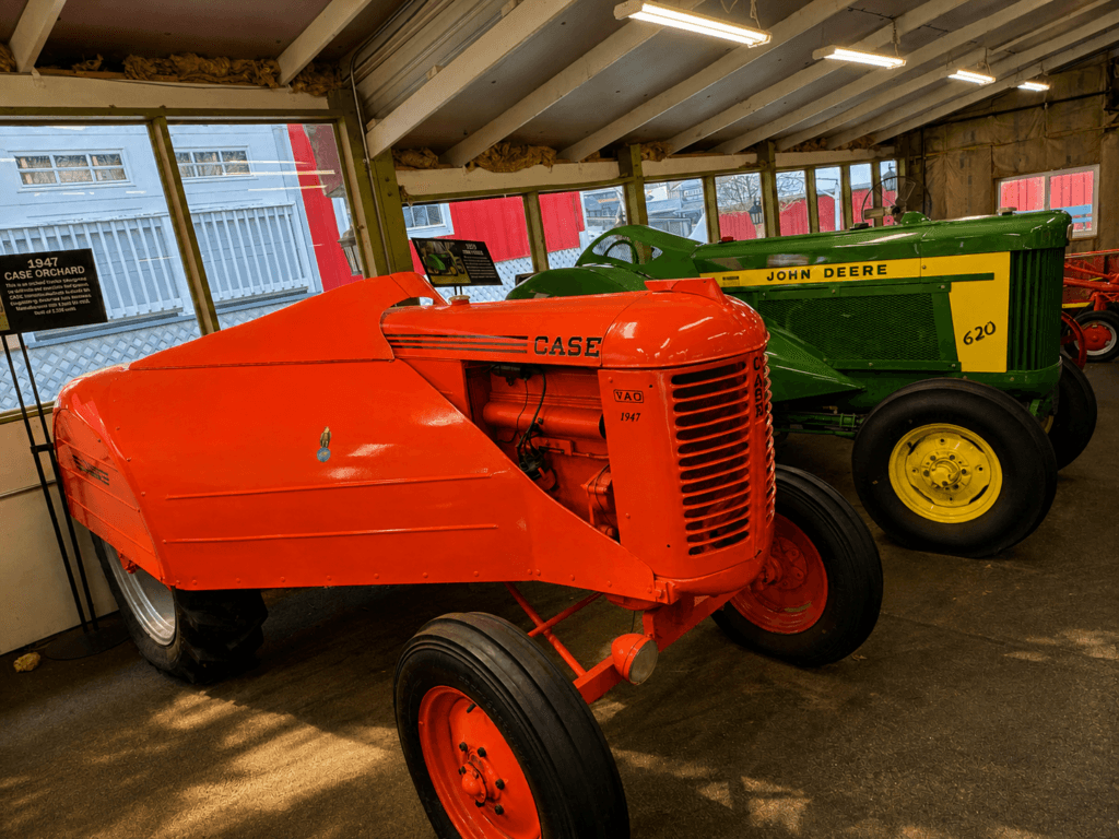 Vintage tractors in a barn setting.