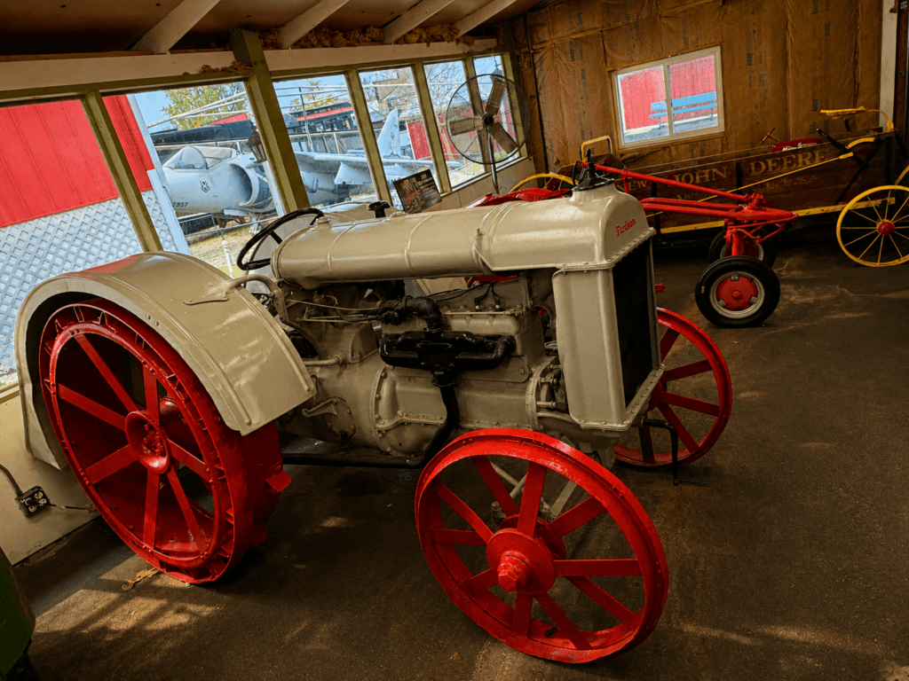Vintage tractors in a barn setting.