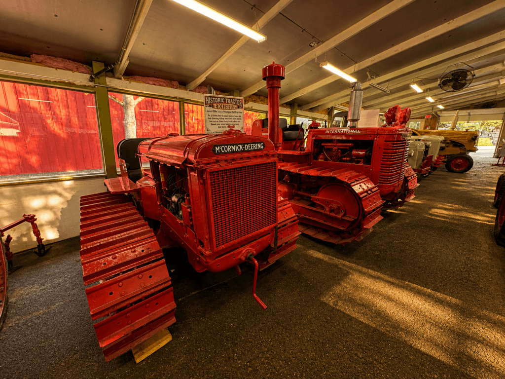 Vintage tractors in a barn setting.