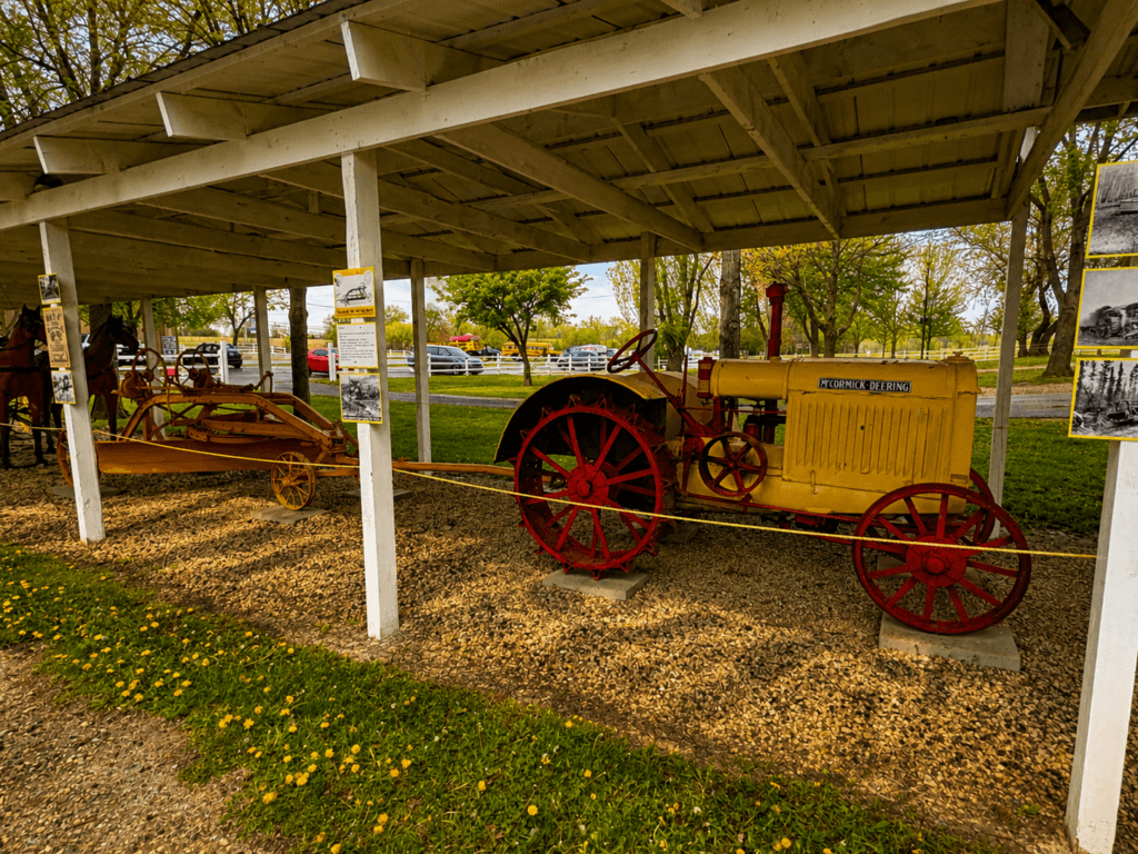 Vintage tractor displayed under shelter