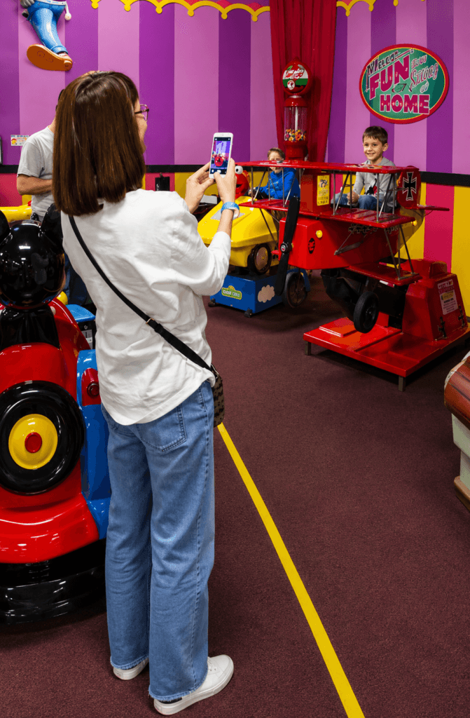 Children playing in a colorful arcade.