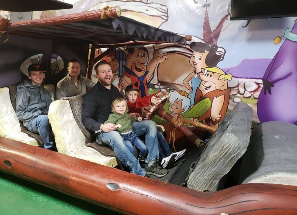 Group enjoying a themed photo booth inside of the flint mobile