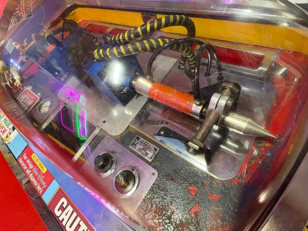 Old arcade machine with colorful controls micromold machine