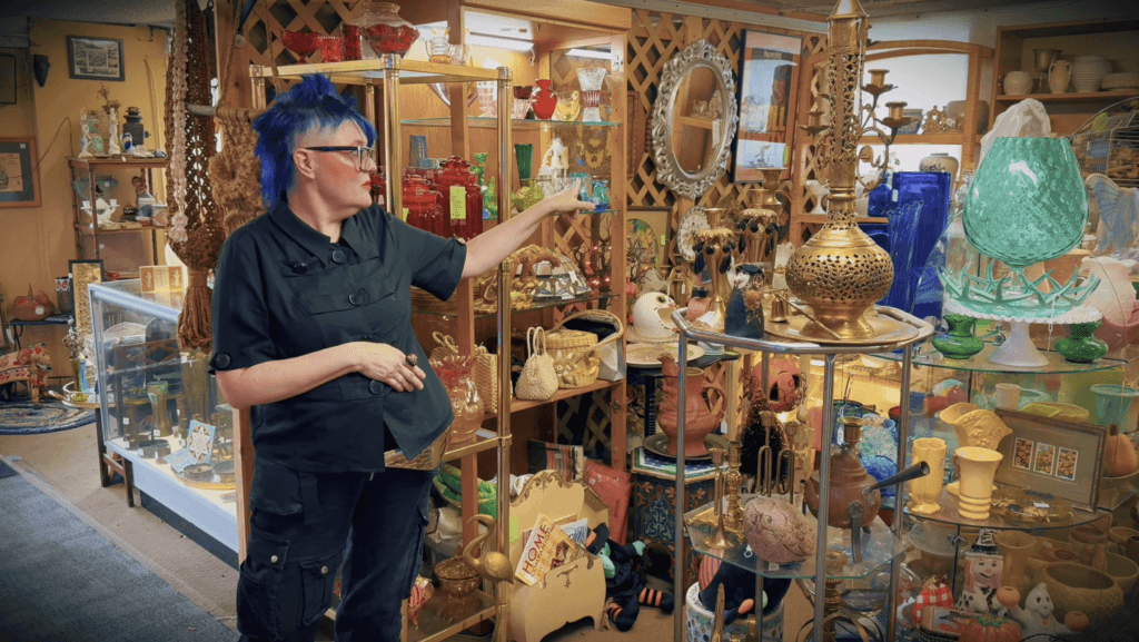Person showcasing vintage collectibles in store.