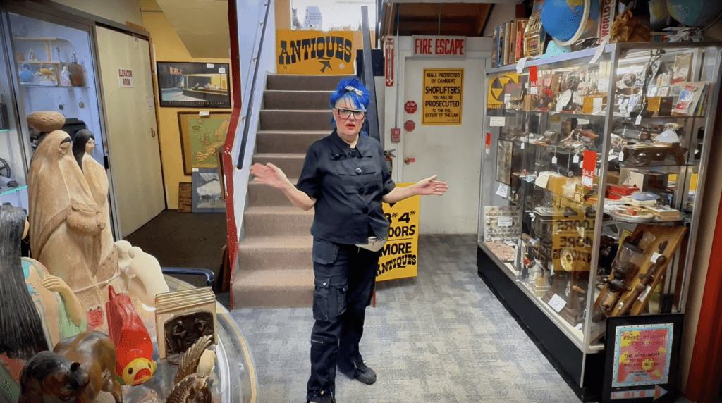 Woman in antique store, colorful decor.