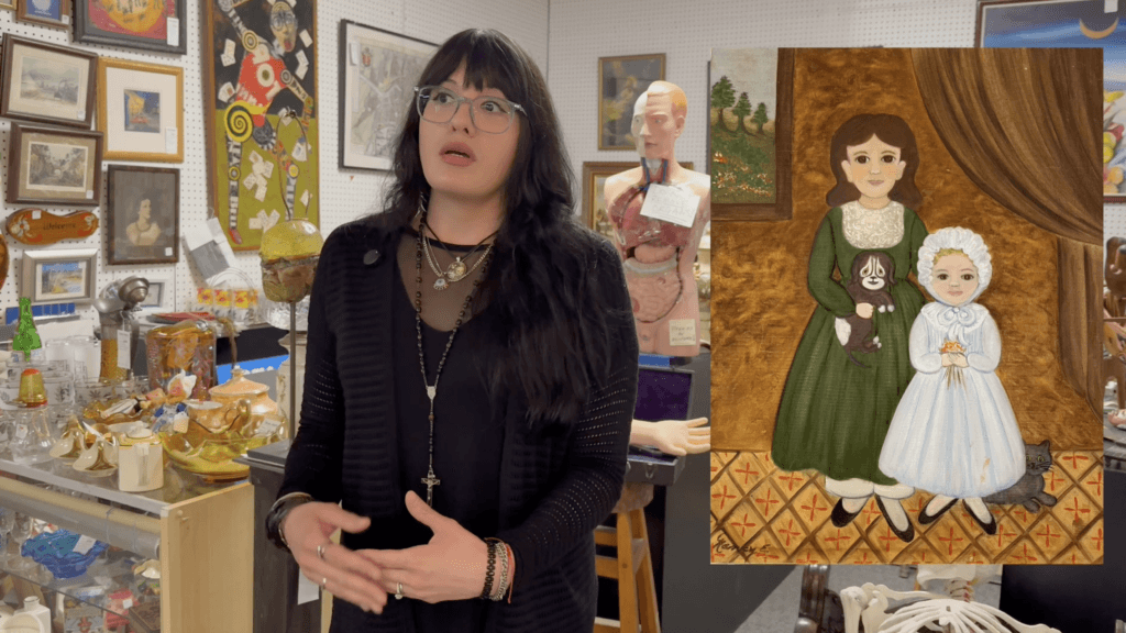 Woman discussing painting in antique shop